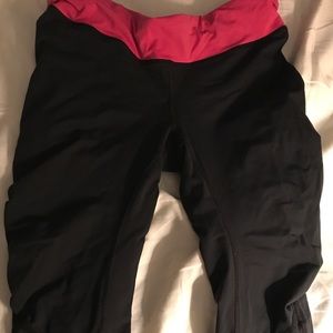 Lululemon black crops with pink waistband. Size 8.